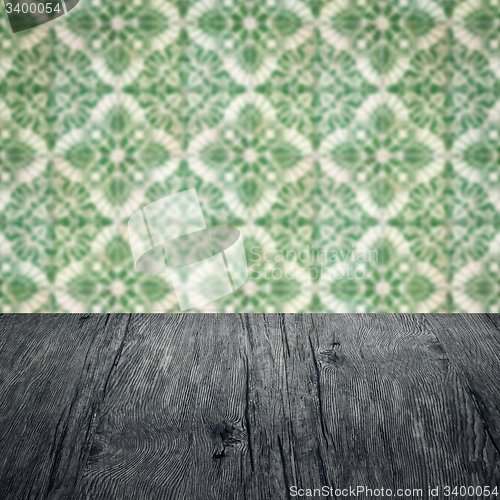 Image of Wood table top and blur vintage ceramic tile pattern wall