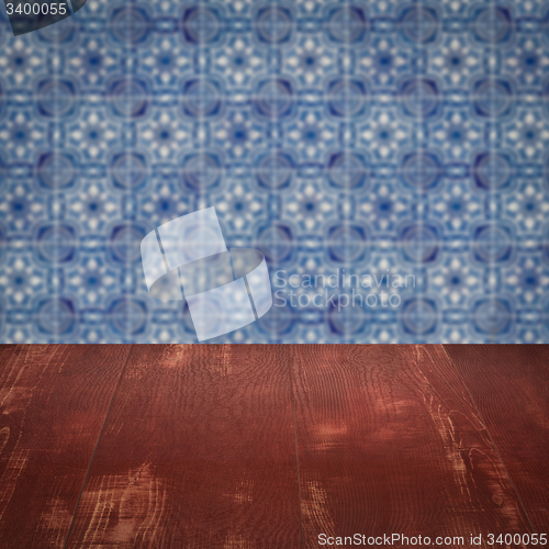 Image of Wood table top and blur vintage ceramic tile pattern wall