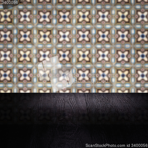 Image of Wood table top and blur vintage ceramic tile pattern wall