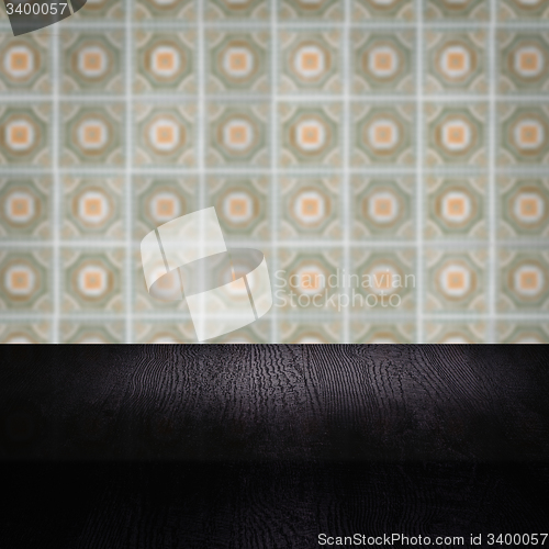 Image of Wood table top and blur vintage ceramic tile pattern wall