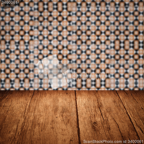 Image of Wood table top and blur vintage ceramic tile pattern wall