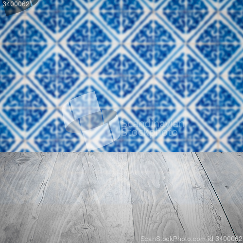 Image of Wood table top and blur vintage ceramic tile pattern wall