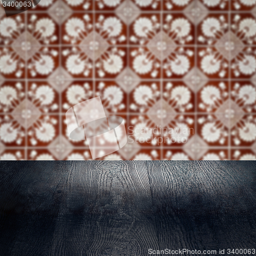 Image of Wood table top and blur vintage ceramic tile pattern wall