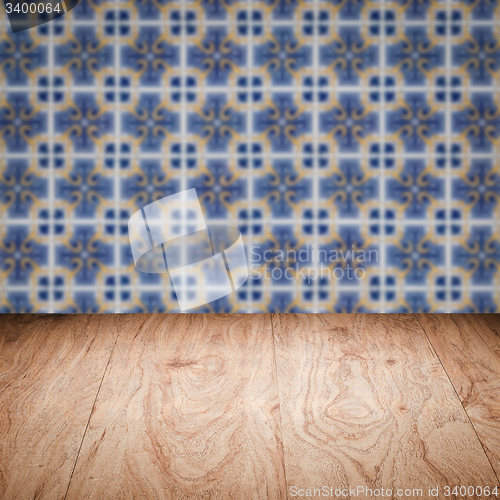 Image of Wood table top and blur vintage ceramic tile pattern wall