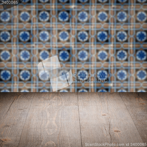 Image of Wood table top and blur vintage ceramic tile pattern wall