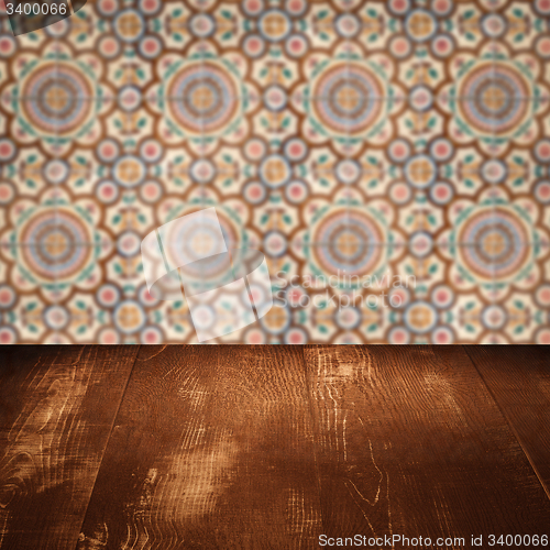 Image of Wood table top and blur vintage ceramic tile pattern wall
