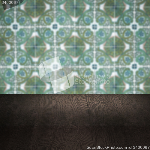 Image of Wood table top and blur vintage ceramic tile pattern wall