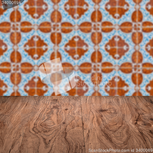 Image of Wood table top and blur vintage ceramic tile pattern wall