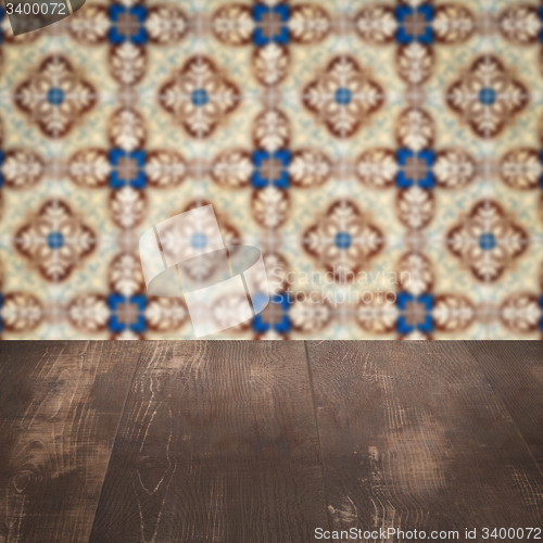 Image of Wood table top and blur vintage ceramic tile pattern wall