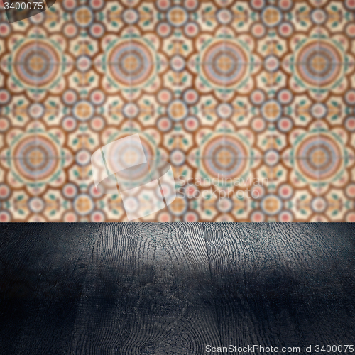 Image of Wood table top and blur vintage ceramic tile pattern wall