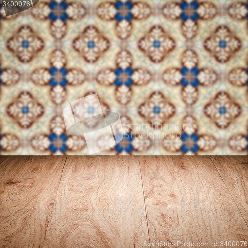 Image of Wood table top and blur vintage ceramic tile pattern wall