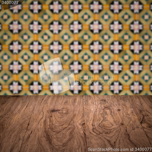 Image of Wood table top and blur vintage ceramic tile pattern wall