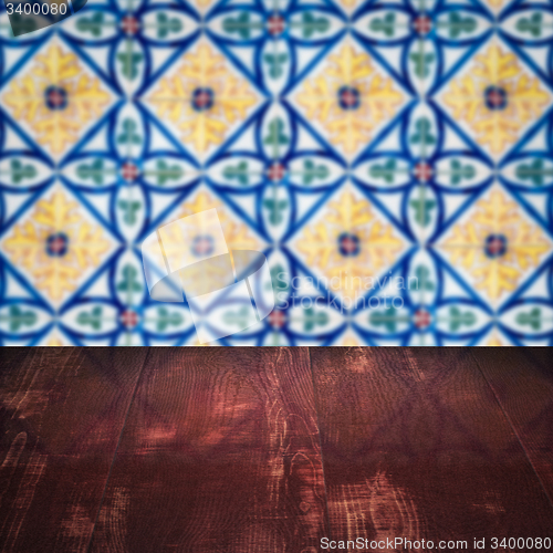 Image of Wood table top and blur vintage ceramic tile pattern wall