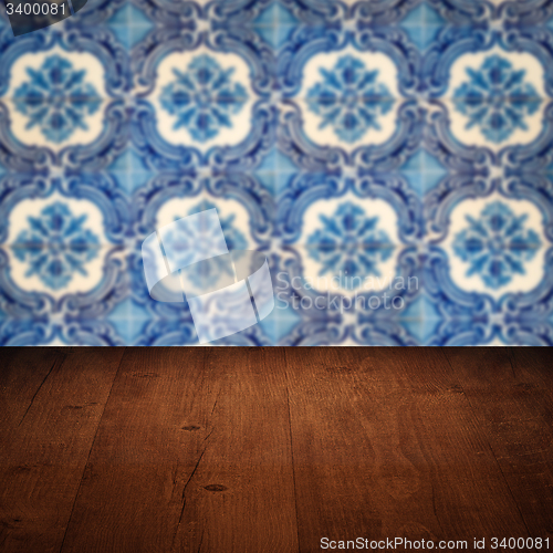 Image of Wood table top and blur vintage ceramic tile pattern wall