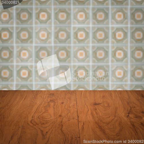Image of Wood table top and blur vintage ceramic tile pattern wall