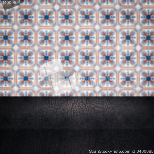 Image of Wood table top and blur vintage ceramic tile pattern wall