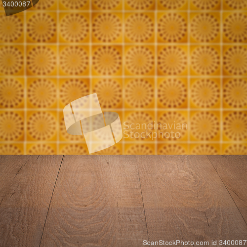 Image of Wood table top and blur vintage ceramic tile pattern wall