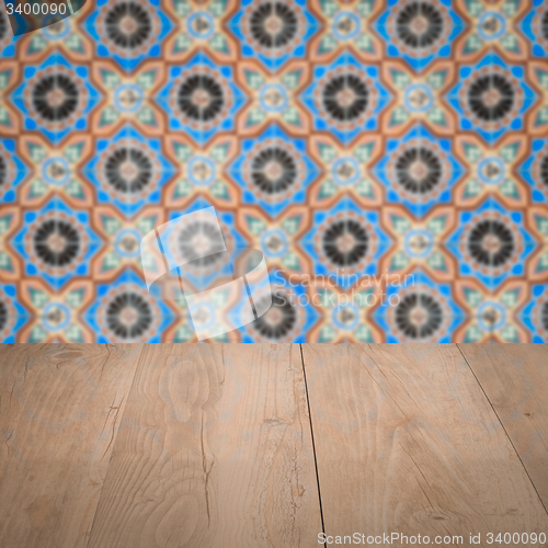 Image of Wood table top and blur vintage ceramic tile pattern wall