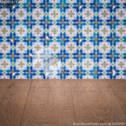 Image of Wood table top and blur vintage ceramic tile pattern wall