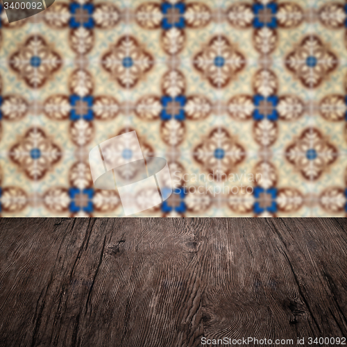 Image of Wood table top and blur vintage ceramic tile pattern wall