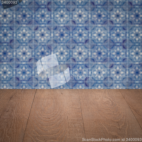 Image of Wood table top and blur vintage ceramic tile pattern wall