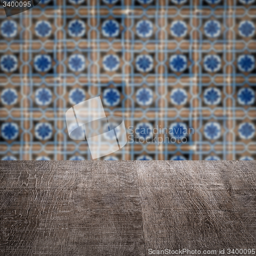 Image of Wood table top and blur vintage ceramic tile pattern wall
