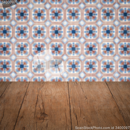 Image of Wood table top and blur vintage ceramic tile pattern wall