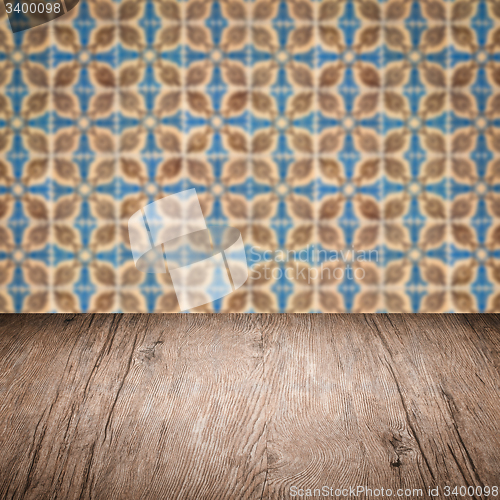 Image of Wood table top and blur vintage ceramic tile pattern wall
