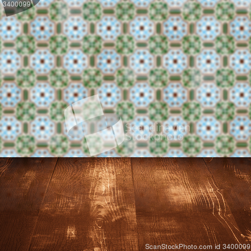 Image of Wood table top and blur vintage ceramic tile pattern wall