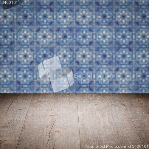 Image of Wood table top and blur vintage ceramic tile pattern wall