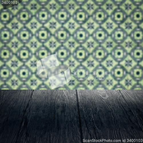 Image of Wood table top and blur vintage ceramic tile pattern wall