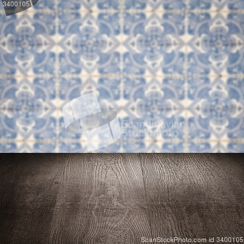 Image of Wood table top and blur vintage ceramic tile pattern wall