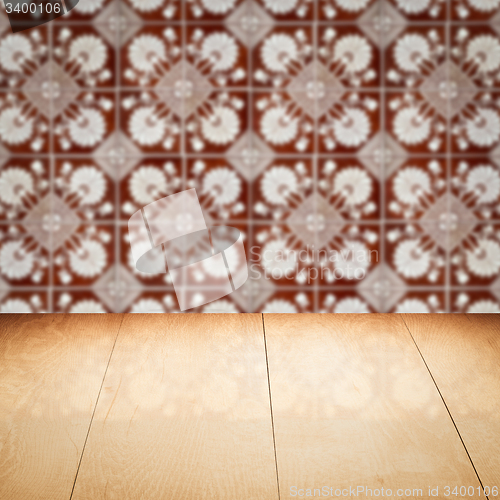 Image of Wood table top and blur vintage ceramic tile pattern wall