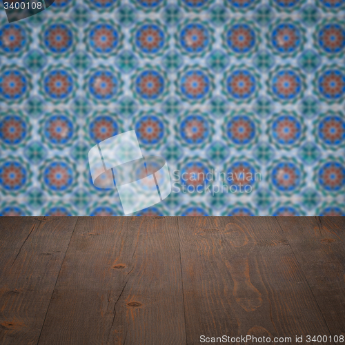 Image of Wood table top and blur vintage ceramic tile pattern wall