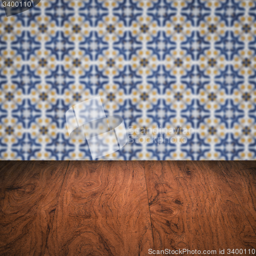 Image of Wood table top and blur vintage ceramic tile pattern wall