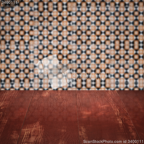 Image of Wood table top and blur vintage ceramic tile pattern wall