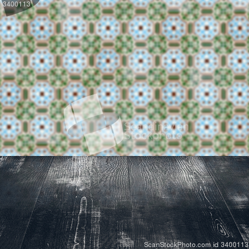 Image of Wood table top and blur vintage ceramic tile pattern wall