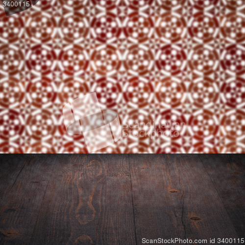 Image of Wood table top and blur vintage ceramic tile pattern wall