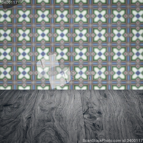 Image of Wood table top and blur vintage ceramic tile pattern wall