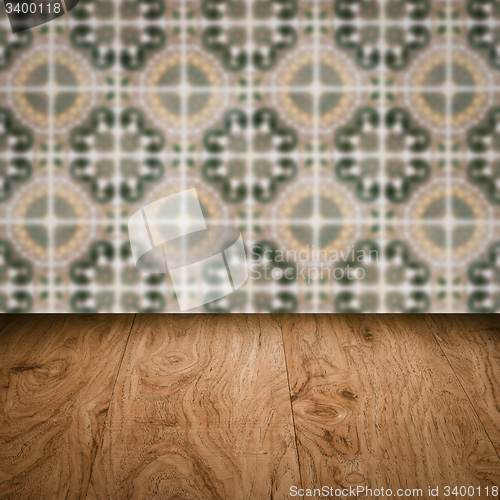 Image of Wood table top and blur vintage ceramic tile pattern wall