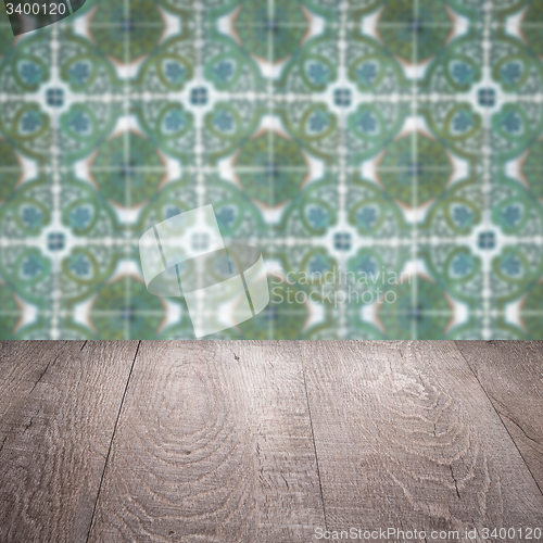 Image of Wood table top and blur vintage ceramic tile pattern wall