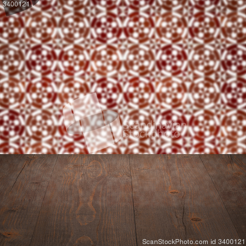 Image of Wood table top and blur vintage ceramic tile pattern wall