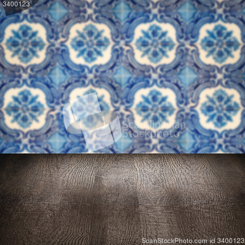Image of Wood table top and blur vintage ceramic tile pattern wall
