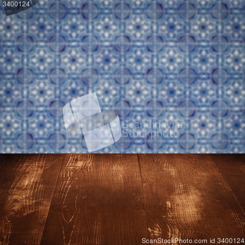 Image of Wood table top and blur vintage ceramic tile pattern wall