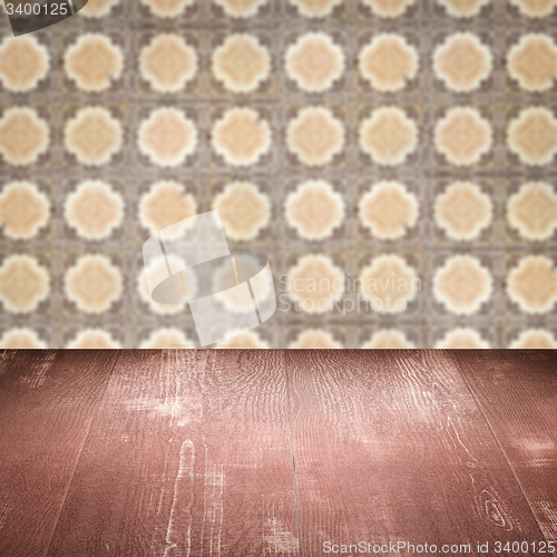 Image of Wood table top and blur vintage ceramic tile pattern wall