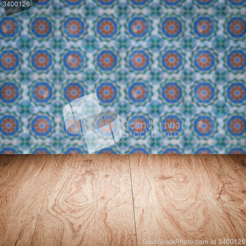 Image of Wood table top and blur vintage ceramic tile pattern wall