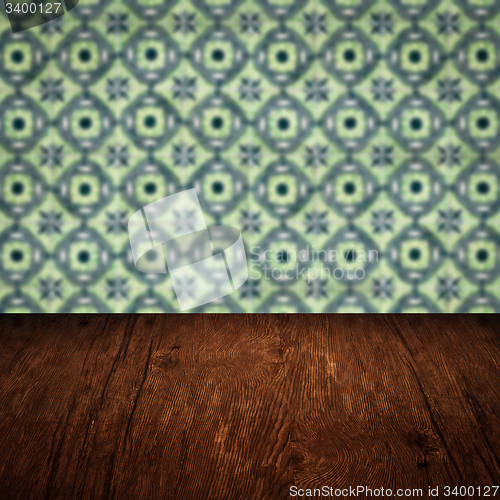 Image of Wood table top and blur vintage ceramic tile pattern wall