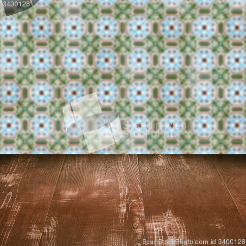 Image of Wood table top and blur vintage ceramic tile pattern wall