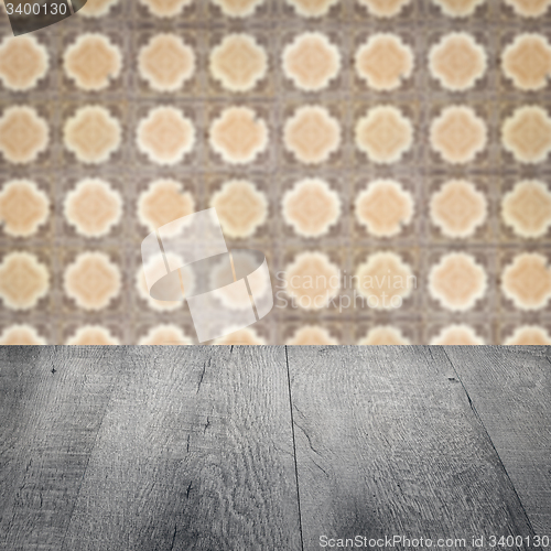 Image of Wood table top and blur vintage ceramic tile pattern wall