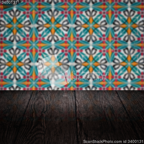 Image of Wood table top and blur vintage ceramic tile pattern wall
